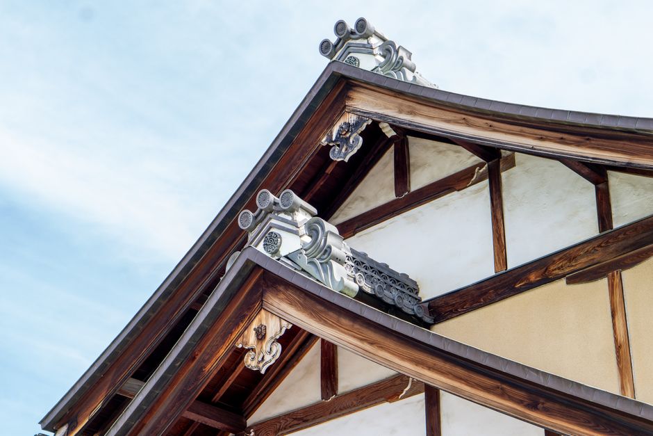 Close-up of traditional Japanese roof architecture showcasing intricate wooden joinery and ornate design.